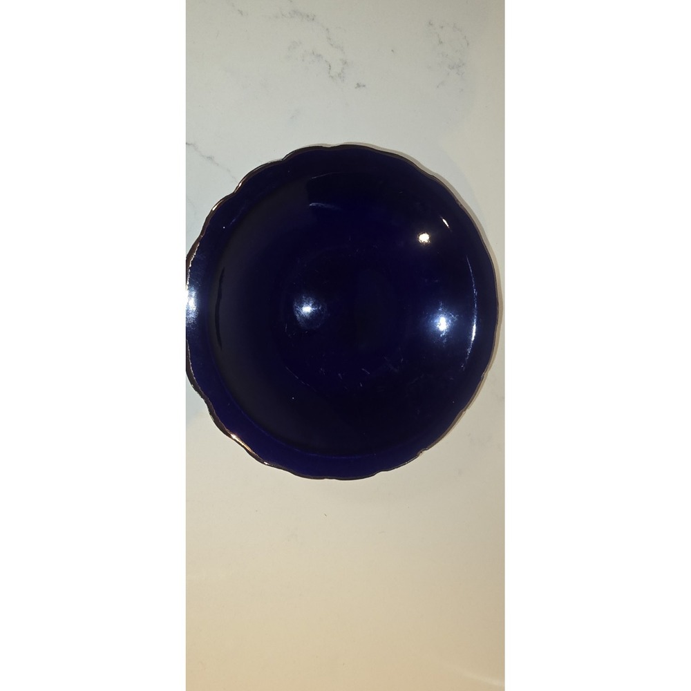 Cobalt blue porcelain dish featuring a scalloped decorative gold gilding edge